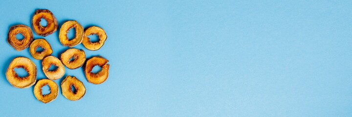 slices of dried persimmon on a blue background. dried fruits. eco.