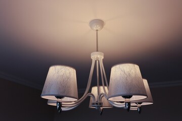 Chandelier in shades of white and silver with the lights on