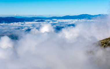 Fototapeta premium The so-called sea of clouds above the lowlands, and above them emerging mountain ranges.