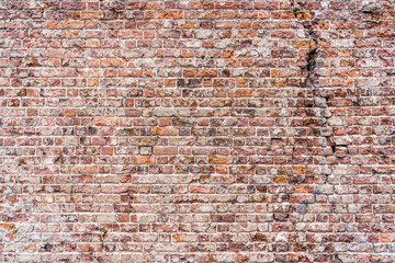 Old, rustic red corroded and damaged brick wall. High quality texture and background for your projects and creative work