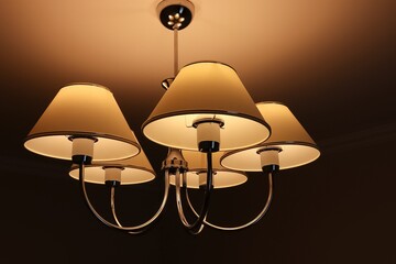 White and gray chandelier with orange light