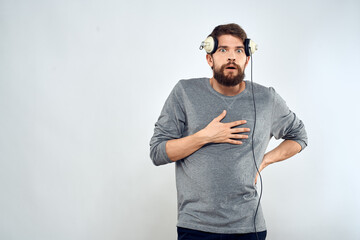 Man in headphones listens to music lifestyle modern style technology light background