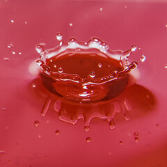 The cost of water background - water splash isolated on red background
