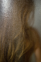 girl with long hair in a swimsuit takes a shower