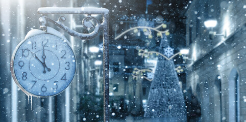 Vintage street clock in winter. New year time