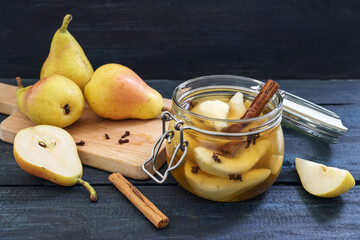 Preserving pears after the harvest with cinnamon and cloves in glass jars to have summer fruit also...