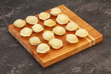Raw dumplings over board for cooking