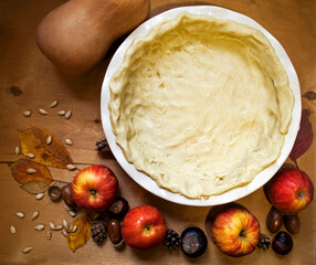 Gluten Free Slicing for Pie and autumn leaves, apples and chestnuts on a wooden background. Autumn composition. Square orientation.