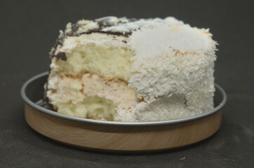 A bitten-off cake on a metal stand .