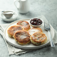 Traditional homemade cottage cheese cakes with berry sauce