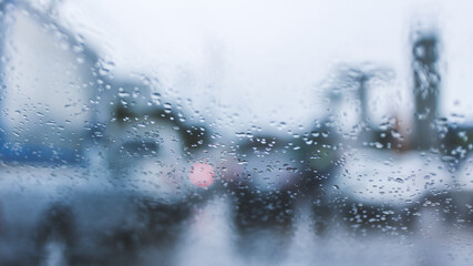 driving car on road in the rain with raindrop over the wind shield, traffic jam in rainy season