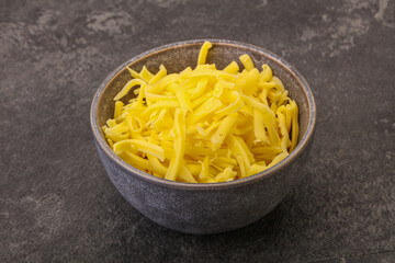 Shredded yellow cheese in the bowl