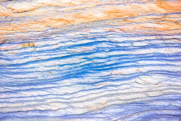 Rock layers - a colorful formations of sedimentary rocks stacked over the hundreds of years. Abstract background with fascinating texture for graphic design.