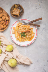 Thin pancakes (crepes) with apple filling, stuffed rolls, Russian traditional food for maslenitsa, French dessert, breakfast with tulips on mother's day