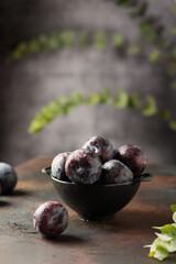 Red sweet plums on the black background
