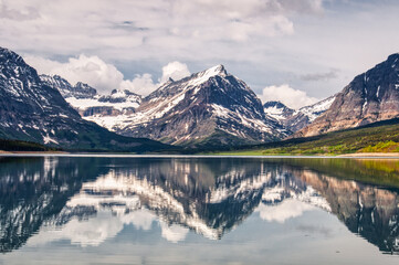 Fototapeta na wymiar Mirrored Mountains and Clouds at Glacier National Park