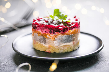 Shuba salad. Russian layered salad with beet, potato, carrot,  pickled herring and mayonnaise for Christmas dinner