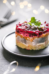 Shuba salad. Russian layered salad with beet, potato, carrot,  pickled herring and mayonnaise for Christmas dinner