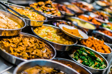 Traditional Asian dishes sold in a food court in Singapore