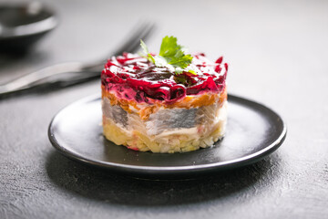 Shuba salad. Russian layered salad with beet, potato, carrot,  pickled herring and mayonnaise for Christmas dinner