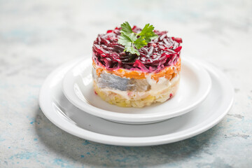 Shuba salad. Russian layered salad with beet, potato, carrot,  pickled herring and mayonnaise for Christmas dinner