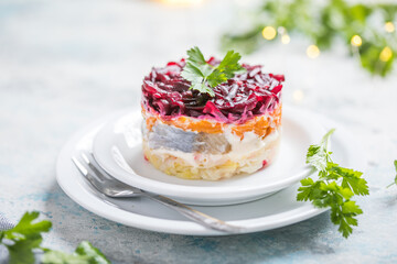 Shuba salad. Russian layered salad with beet, potato, carrot,  pickled herring and mayonnaise for Christmas dinner
