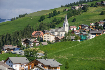 Fototapeta na wymiar La Val village and its surrounding churches, Alta Badia, Dolomites, South Tirol, Italy.