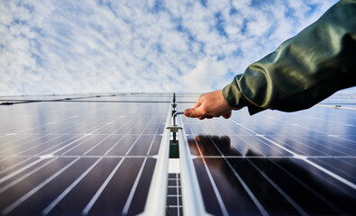 Close-up of installer's hand holding hex key, fastening metal carcass to maintain solar batteries....