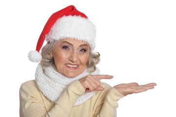 Portrait of smiling happy senior woman in Santa hat posing