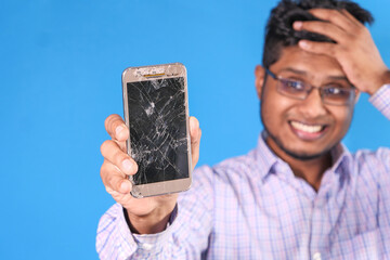 Close up of man hand holding broken smart phone.