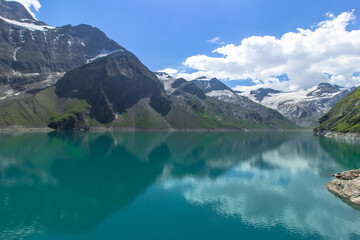 Beautiful view of high mountain lake near Kaprun.Hike to the Mooserboden dam in Austrian Alps.Quiet relaxation in nature.Wonderful nature landscape,turquoise tranquil lake,holiday travel scene.