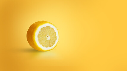 Isolated lemon sliced on a yellow background. Vitamin