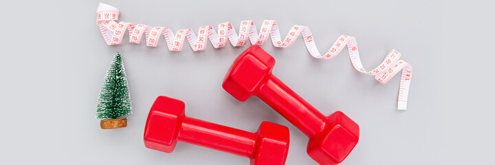 Exercise, Fitness and Working Out Merry Christmas and Happy new year concept. Sports equipment on gray background with copy space. Flat lay, Top view, overhead, mockup