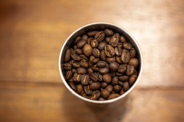 The coffee seed put on wood background, top view