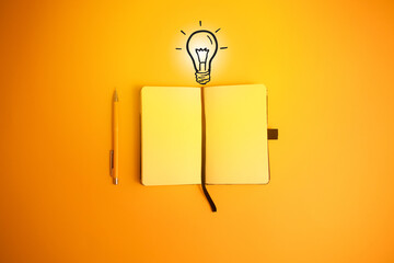Light bulb and blank notebook. Creativity, idea and innovation concept.