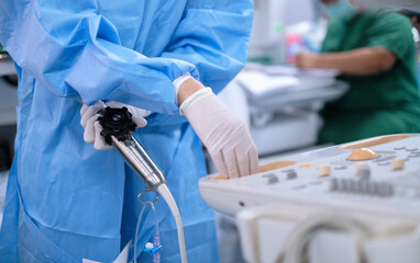 Cardiologist holding transesophageal ultrasound probe and use echocardiogram to assessment...