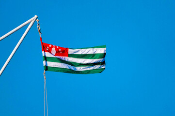 State Flag of Republic of Abkhazia against blue sky