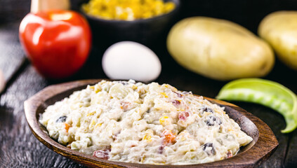 mayonnaise with vegetables, Brazilian tradition. Mayonnaise with corn, lentils, tomatoes, eggs and raisins.