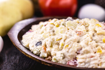 mayonnaise with vegetables, Brazilian tradition. Mayonnaise with corn, potatoes, lentils, tomatoes, eggs and raisins. Brazilian garrison for parties and events