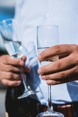 two hands holding glasses of champagne