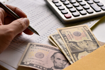 Close-up view, Dollar money and income calculation.
