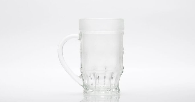 Beer Poured Into A Glass On A White Background
