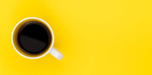 Top view, flat lay of black coffee cup on background yellow.