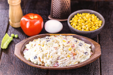 Brazilian mayonnaise, with fruits and vegetables, rustic kitchen, wooden utensils in the background