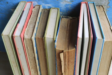 Close-up of old books arranged in the library Old wooden floor as background selective focus and shallow depth of field