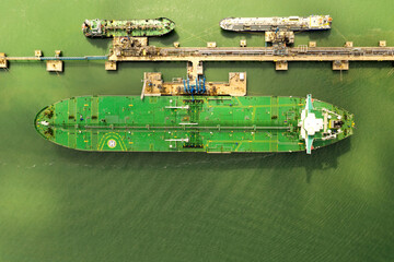 Aerial view of a large ship with helicopter landing pad moored up with a gas tanker. Ships on...