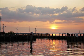 Obraz premium Sunset by the harbor entrance.