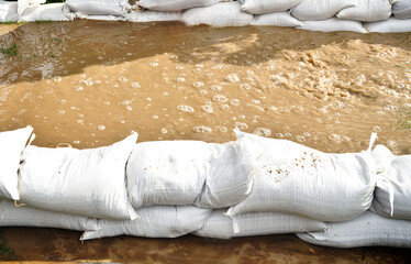 Sand bags surround flood water