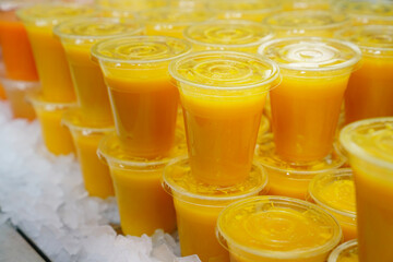 Mixed ice cold juice glasses in the market, close up