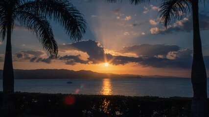 Sunset with orange and blue sky over the Jamaican ocean.